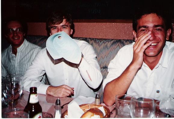 Three men at a meal table