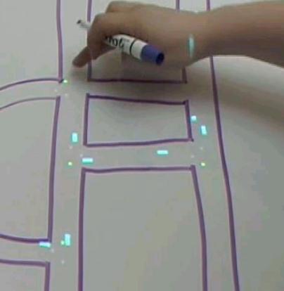 Whiteboard with marked road network and projected vehicles
